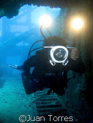 Videographer (Tito) inside the wreck of the WIT Shoal in ... by Juan Torres 